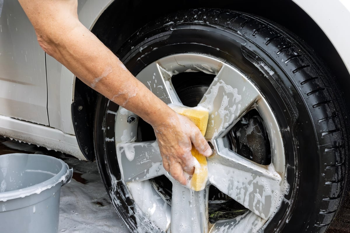 Washing car wheel with sponge
